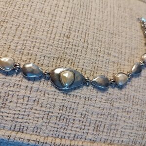 Silver tone faux pearl bracelet.